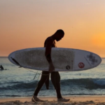 playa venao panama surf camp man holding surf board