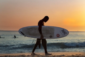 playa venao panama surf camp man holding surf board