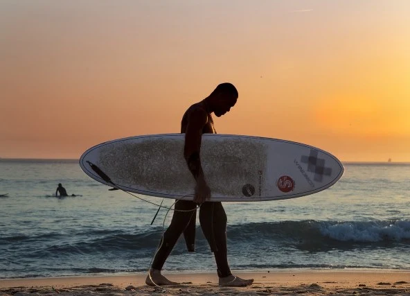 playa venao panama surf camp man holding surf board