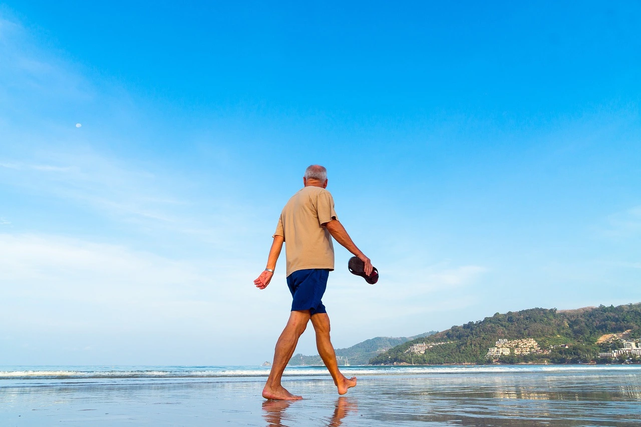 retiring in panama senior man walking on beach