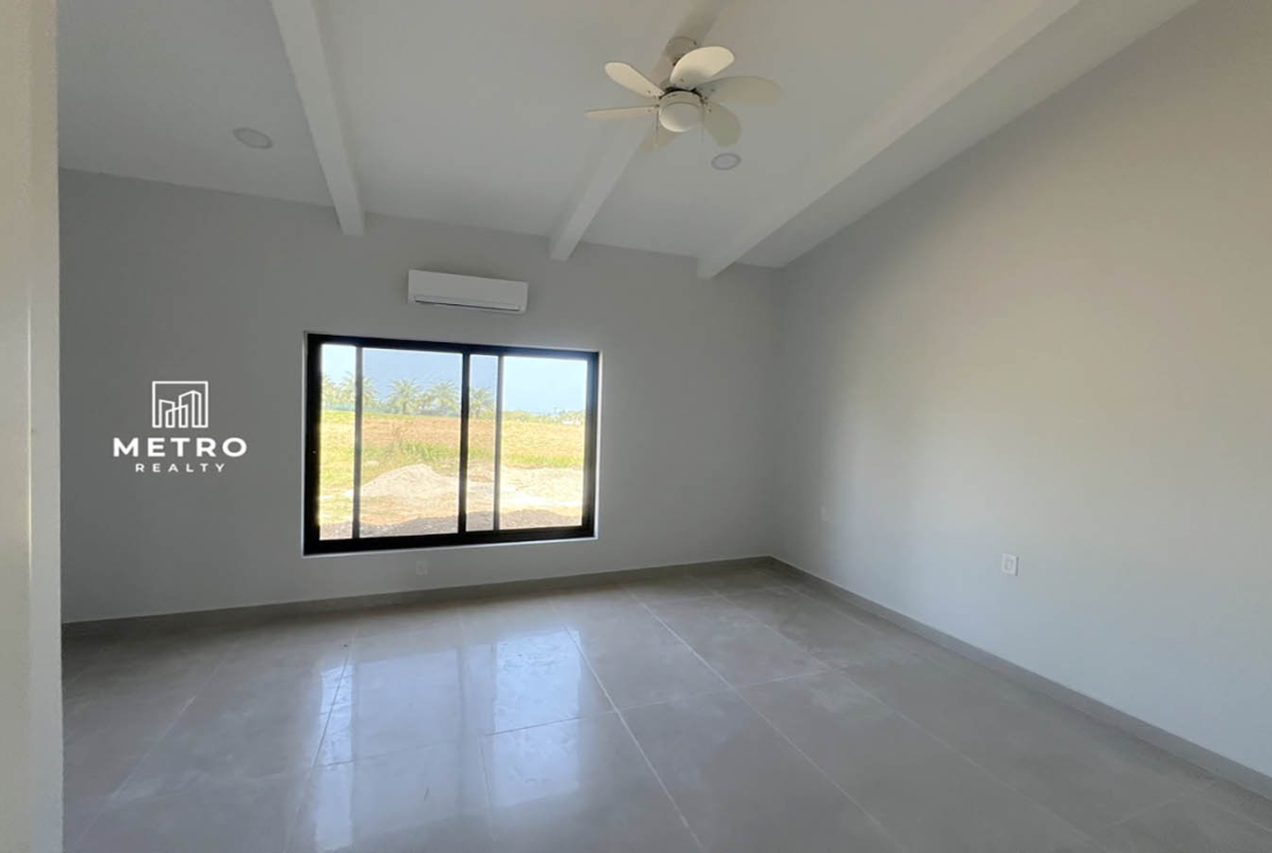 Andromeda Pedasi house for sale bedroom window yellow house bedroom